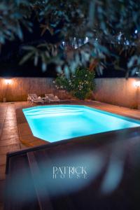 a blue swimming pool in a backyard at night at Chambre privée avec Piscine in Marseille +2 photos