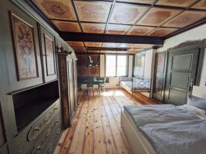 a bedroom with a bed and a wooden floor at Schloss Mörlbach in Icking