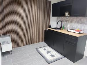 a kitchen with a sink and a counter top at Jasmins Airbnb in Einigen +2 photos