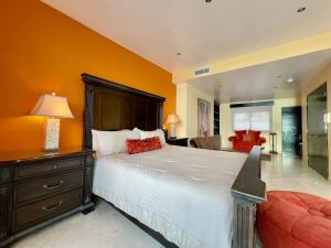 a bedroom with a large bed and a living room at Oceanfront Villa 4BR 4 BA Real Mediterraneo in Tijuana