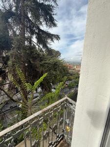 a balcony with a tree and a view of a city at La Sorpresa in Huétor Vega