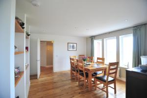 a kitchen and dining room with a table and chairs at Beinn Edra House B&B in Staffin