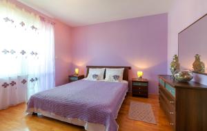een slaapkamer met een bed met paarse muren en een raam bij Apartment Sophie’s place in Split