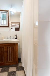 a bathroom with a sink and a mirror at La Toldería - Casas de Campo in Trenque Lauquen +37 photos
