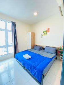 a bedroom with a bed with blue sheets and a window at CHEAPEST PROMO Private Modern King Suites above Mesamall Nilai, 3 Km to USIM in Nilai