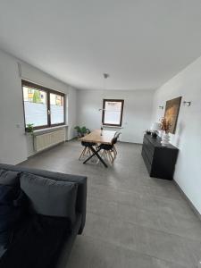a living room with a couch and a table at Ferienwohnung in Kenn in Kenn