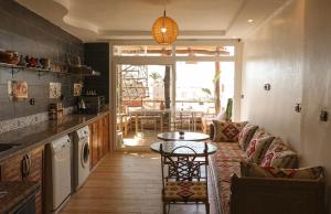a living room with a couch and a table at Artstay in Tamraght Ouzdar +28 photos