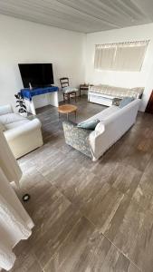 a living room with two beds and a flat screen tv at Casa en playa Quequen in Quequén