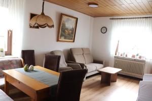 a living room with a table and a couch at Brautrockstube in Bullay +1 photo