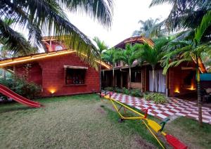 a house with a slide in front of it at Kashid Boutique Resort in Sarne