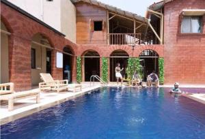 a group of people playing in a swimming pool at Kashid Boutique Resort in Sarne
