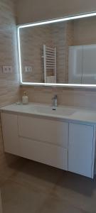 a bathroom with a white sink and a mirror at Casa Doris in Los Alcázares +14 photos
