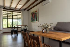 a living room with a wooden table and a couch at La Toldería - Casas de Campo in Trenque Lauquen