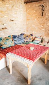 a bench in a room with pillows on it at IBI Surf House in Sidi Kaouki +39 photos