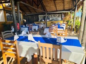 a dining room with blue tables and wooden chairs at Tropical Paradise Nosy Be in Nosy Be +54 photos