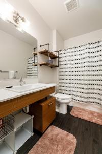 a bathroom with a sink and a toilet at Trailside Charm TART Trail Downtown in Traverse City +35 photos