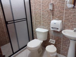 a bathroom with a toilet and a sink at Hotel La Casona Valledupar in Valledupar