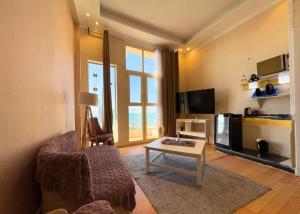 a living room with a couch and a coffee table at Hyat Suites & Rooms in Alexandria