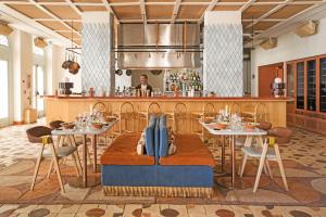 a restaurant with tables and a chef in the kitchen at Montesol Experimental Ibiza in Ibiza Town