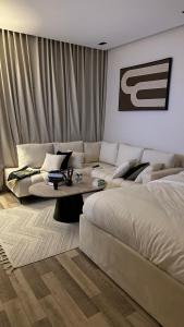 a living room with a bed and a couch at استديو برق بطابع فندقي بحي حطين in Riyadh