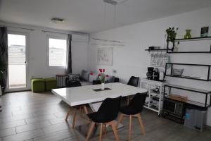 a living room with a white table and chairs at Apartma Javoršček in Bovec
