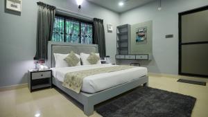 Llit o llits en una habitació de Sort By Stays , Siolim