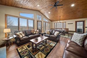 a living room with leather couches and a table at On Beech Time in Beech Mountain