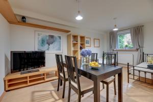 a living room with a table and a television at Apartament 48 in Gdańsk