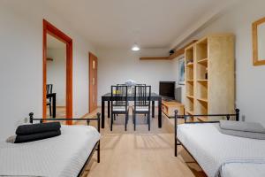 a room with two beds and a dining table at Apartament 48 in Gdańsk +8 photos