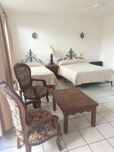 Postel nebo postele na pokoji v ubytování Hotel Quinta Loreto