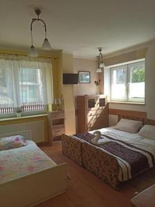 Postel nebo postele na pokoji v ubytování Dom Spokoju - pokoje gościnne, pobyty grupowe