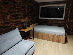 a small room with two beds and a window at Apartament Glamour II Kleszczów in Łękińsko