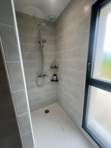 a shower stall in a bathroom with a window at Maison entre océan et forêt landaise in Vielle-Saint-Girons +14 photos