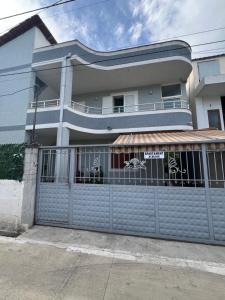 a house with a blue fence with a gate at Ersi Apartment in Durrës