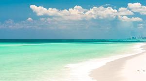 a beach with turquoise water and white sand at Bikini Bottom Destin Harbor Private Gated Beach in Destin