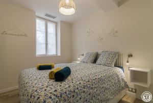 a bedroom with a bed with pillows on it at La maisoun d'odette in Mérenvielle