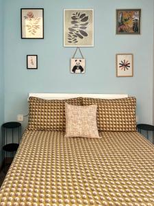 a bedroom with a bed and some pictures on the wall at Seafront Apartment with air conditioner in Empuriabrava