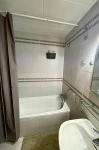 a bathroom with a bath tub and a sink at Seafront Apartment with air conditioner in Empuriabrava
