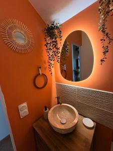 a bathroom with a sink and a mirror at Le Nid dHistoire avec vue sur la cathédrale in Bayeux +18 photos