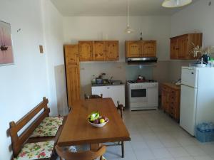 a kitchen with a wooden table with a bowl of fruit on it at Villa Vit The Adriatic Experience in Vasto
