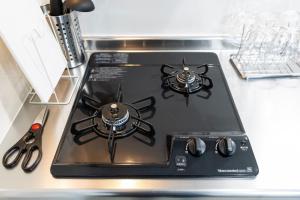 a stove top with two burners on top of it at Villetta Imari Ekimae III Villetta Imari Ekimae II - Vacation STAY 19025 in Imari