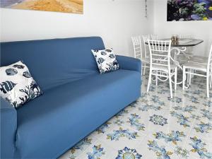 a blue couch in a living room with a table at Casa Helia- Sperlonga in Sperlonga
