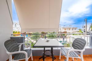 a table and chairs on a balcony with a view at Vila del Mar in Ksamil