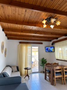 a living room with a couch and a table at Levante Apartment for 4 in Faliraki