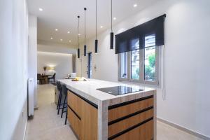 a kitchen with a island with a counter top at BAMBOO Athens Villa in Athens