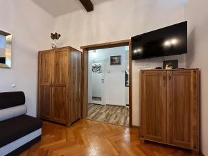 a living room with a flat screen tv on a wall at Old Cracow Apartment I in Krakow