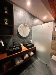 a bathroom with two sinks and a mirror at Cabaña Nurela in Mazamitla +24 photos