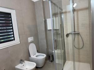 a bathroom with a toilet and a glass shower at Villetta independente la Perla in Ceggia +21 photos