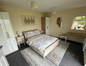 a bedroom with a bed and a desk at Luxury Apartment Heald Green in Handforth