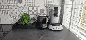 a kitchen counter with a coffee maker and a toaster at EMM Guesthouse in Ieper